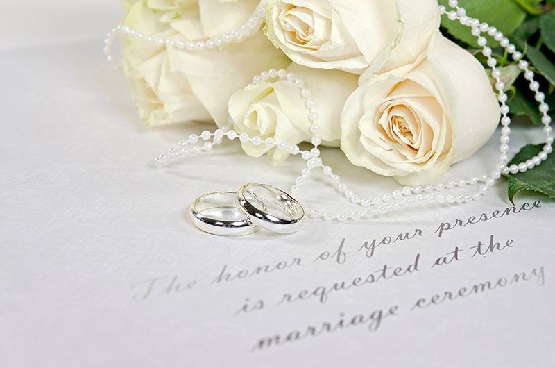 White roses and wedding bands.